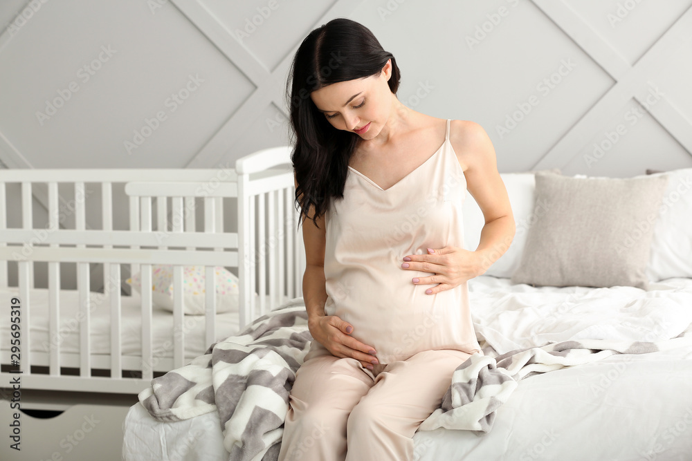 Beautiful young pregnant woman in bedroom Beautiful young pregnant woman in bedroom