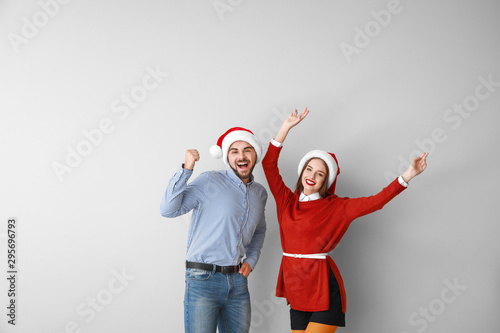 Happy young couple in Santa...