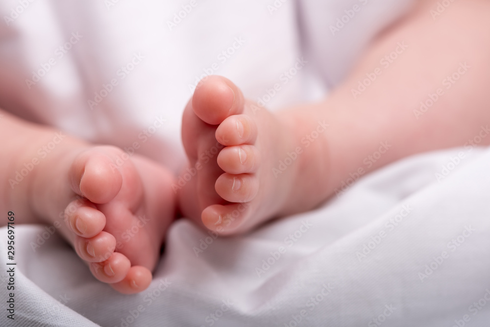 Newborn baby feet on a white blanket. Baby feet.