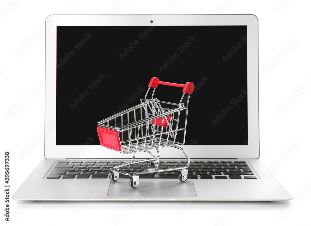 Laptop and small cart on white background. Internet shopping concept