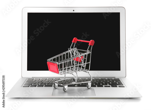 Laptop and small cart on white background. Internet shopping concept