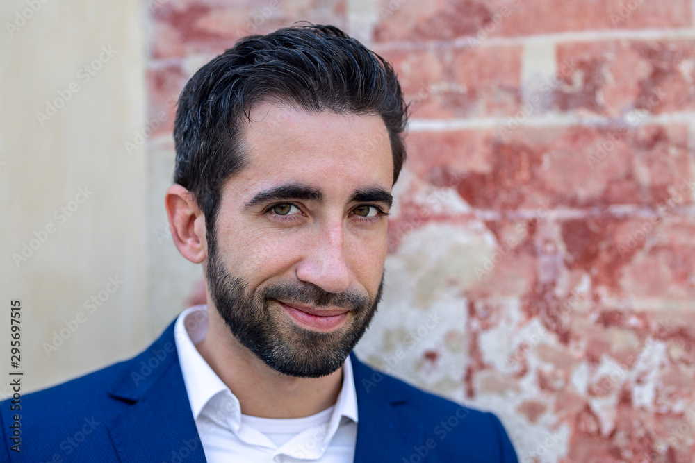 Portrait of stylish handsome young man leaning on wall. Portrait of stylish handsome young man leaning on wall.
