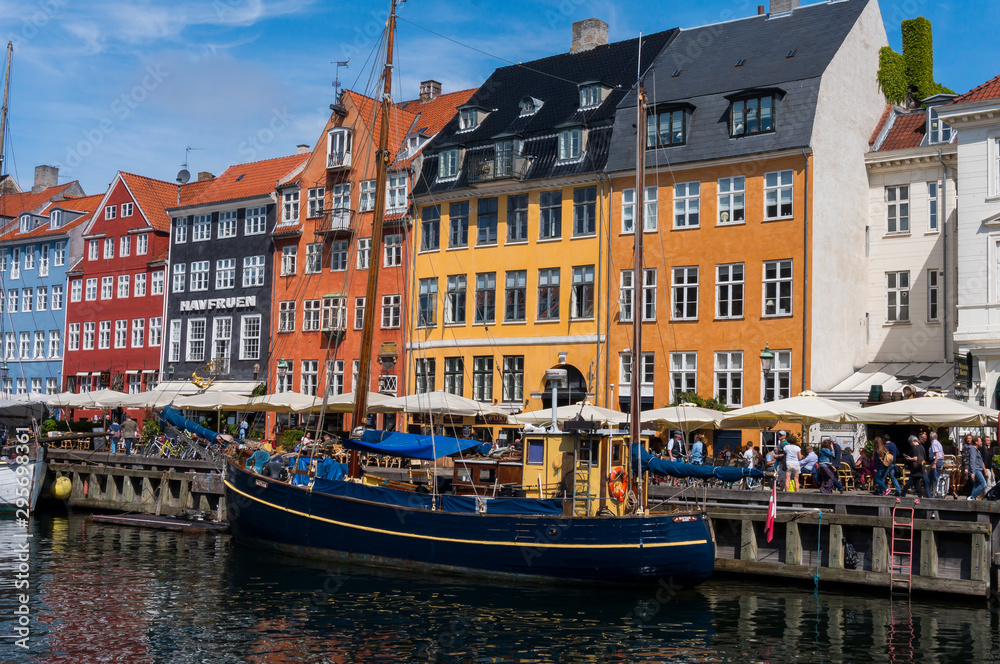 Famous Nyhavn pier with colorful facades of old houses and vintage ships in Copenhagen, capital of Denmark. Summertime in the fantastic city of Copenhagen