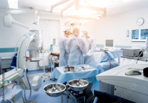 Spinal surgery. Group of surgeons in operating room with surgery equipment. Laminectomy photo