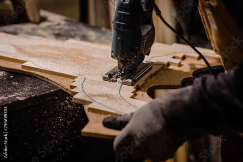 Carpenter using an electric jigsaw