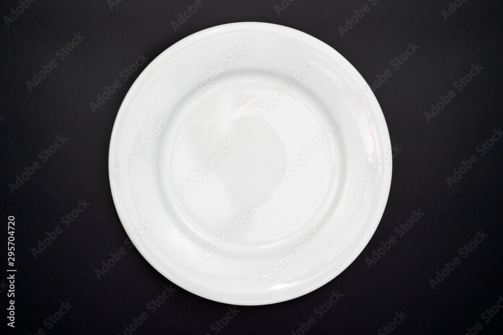 Table setting. Empty plate on a black background. Top view and flat lay with copy space. Table setting. Empty plate on a black background. Top view and flat lay with copy space.