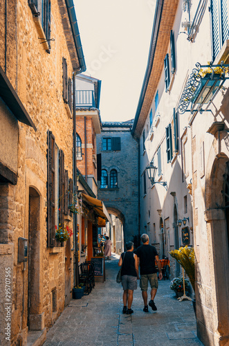 Tourists walk along the old street in San Marino