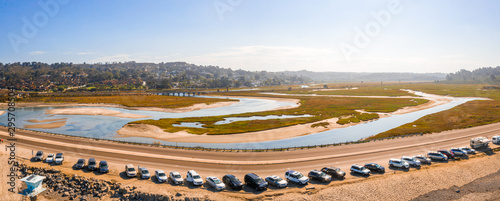Beautiful aerial view of the San Diego coastline with amazing golden beaches, docks and the town itself by the Pacific ocean.