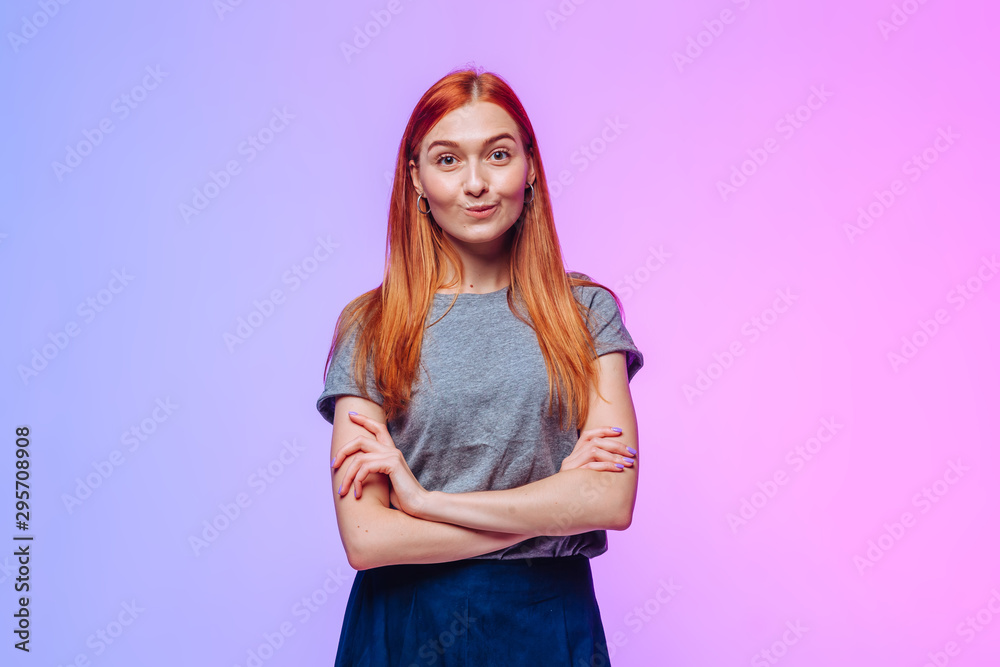 The redhead crosses her arms and smiles The redhead crosses her arms and smiles