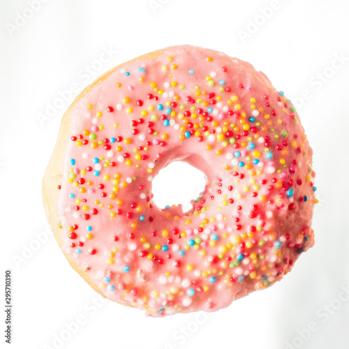 glazed pink donut with rainbow Sprinkles on a light background