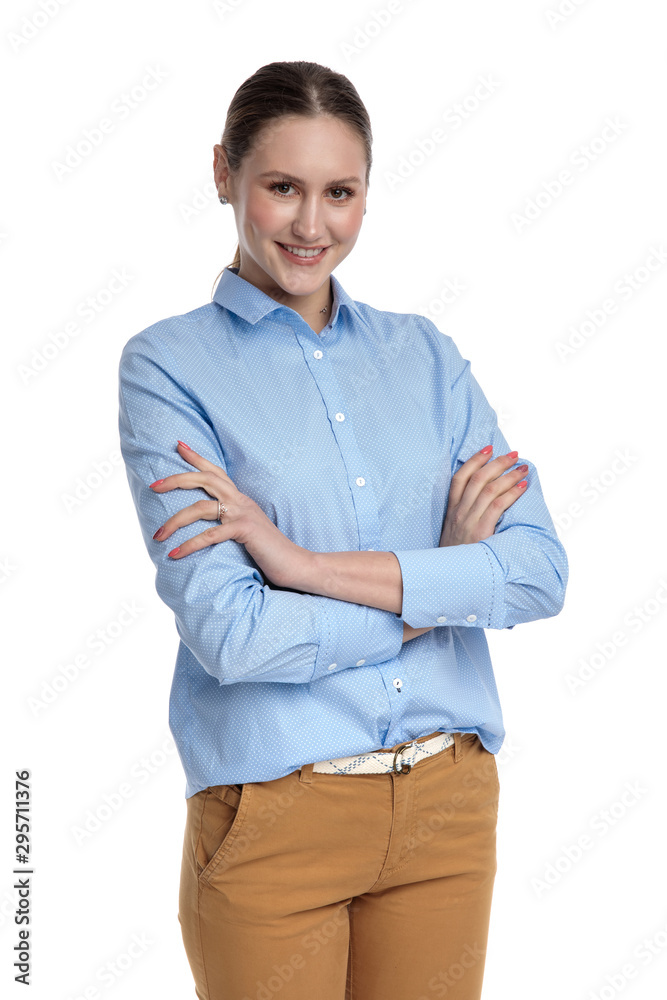 happy young businesswoman crossing arms and smiling happy young businesswoman crossing arms and smiling
