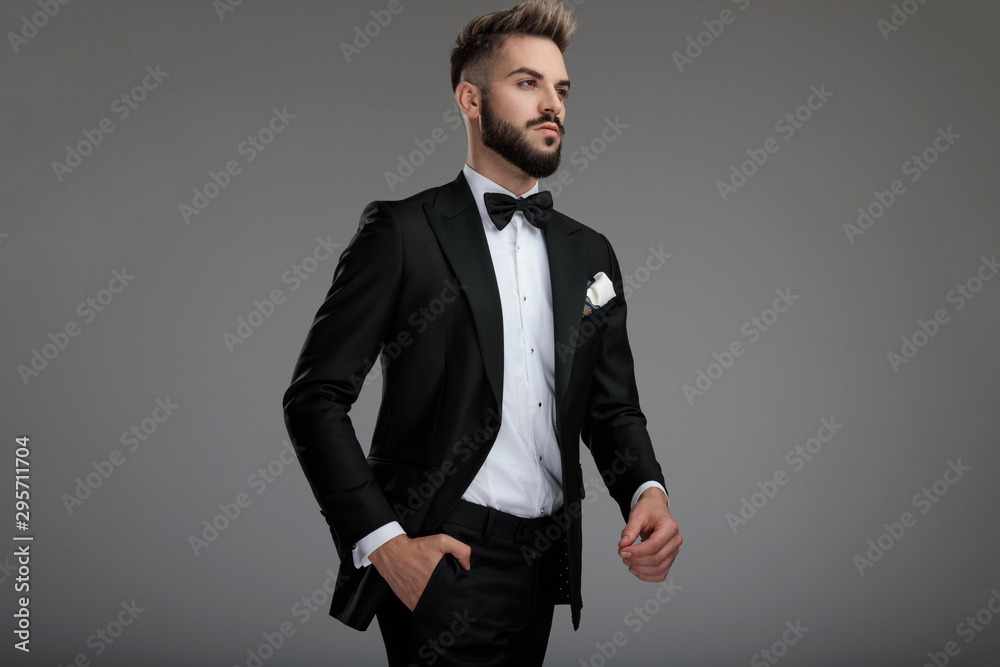 Motivated groom walking and holding a hand in his pocket Motivated groom walking and holding a hand in his pocket