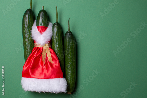 New Year cucumbers on a green background, products on the festive table, Christmas vegetables