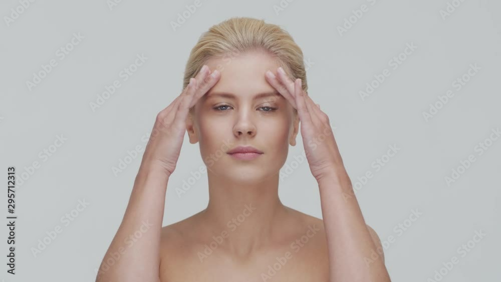 Studio portrait of young, beautiful and natural blond woman applying skin care cream. Face lifting, cosmetics and make-up. Studio portrait of young, beautiful and natural blond woman applying skin care cream. Face lifting, cosmetics and make-up.