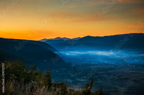 Sunrise with fog, mountains and town in the background. Drvar in Bosnia and Herzegovina. © Milan