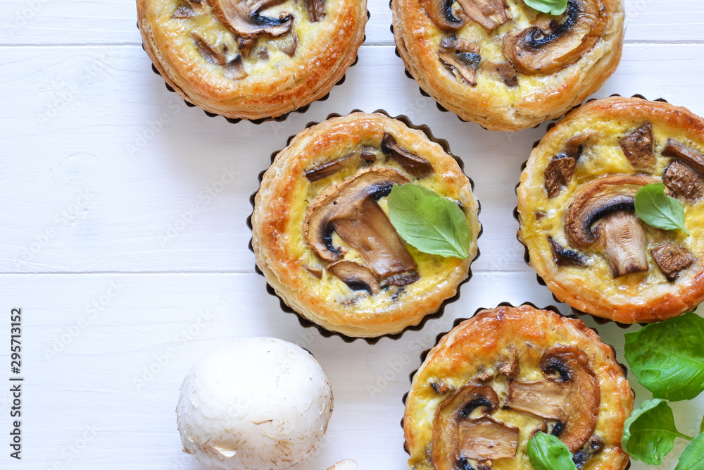 Tartlets with mushrooms and chicken on a wooden background. View from above.