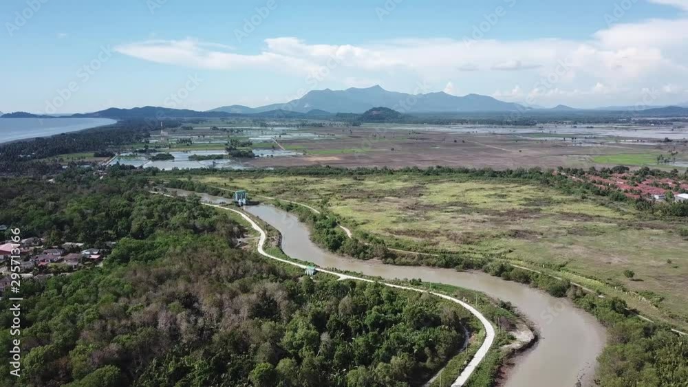 Fly over the river with background near Kuala Muda with background paddy field and Gunung Jerai. Fly over the river with background near Kuala Muda with background paddy field and Gunung Jerai.