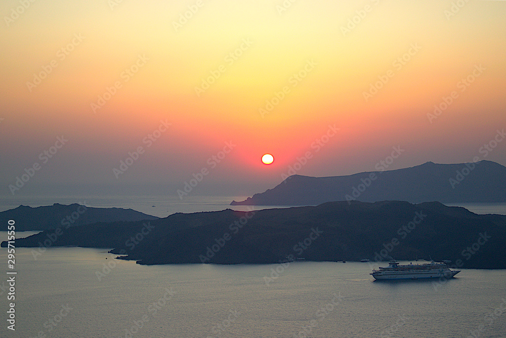 Sunset in Santorini Greece with a view at the volcano.