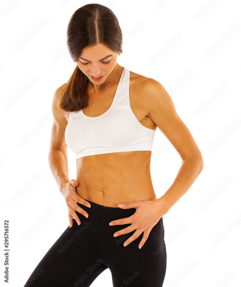 Fitness model with a flat stomach isolated on a white background Fitness model with a flat stomach isolated on a white background