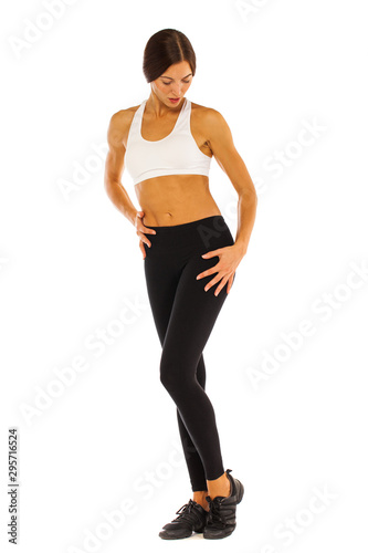 Young healthy girl doing exercises, full length portrait isolated over white background © Andrey_Arkusha