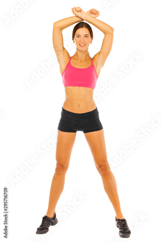 Young fitness brunette woman in red top and black shorts