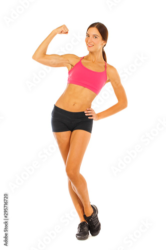 Young fitness brunette woman in red top and black shorts