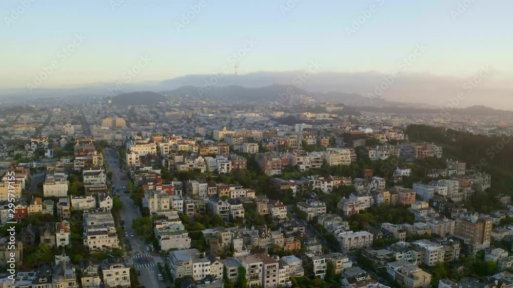 Aerial, descending, drone shot, tilting towards buildings on a hill, in San Francisco city, at sunrise, on a sunny, summer morning, in California, USA Aerial, descending, drone shot, tilting towards buildings on a hill, in San Francisco city, at sunrise, on a sunny, summer morning, in California, USA