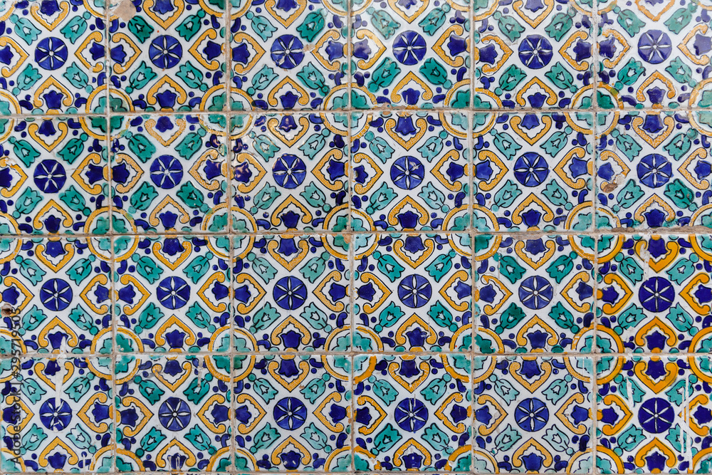 Old traditional Tunisian tiles.  Handmade Tunisian tiles with floral patterns. Islamic mosaic art pattern. Background of vintage ceramic tiles