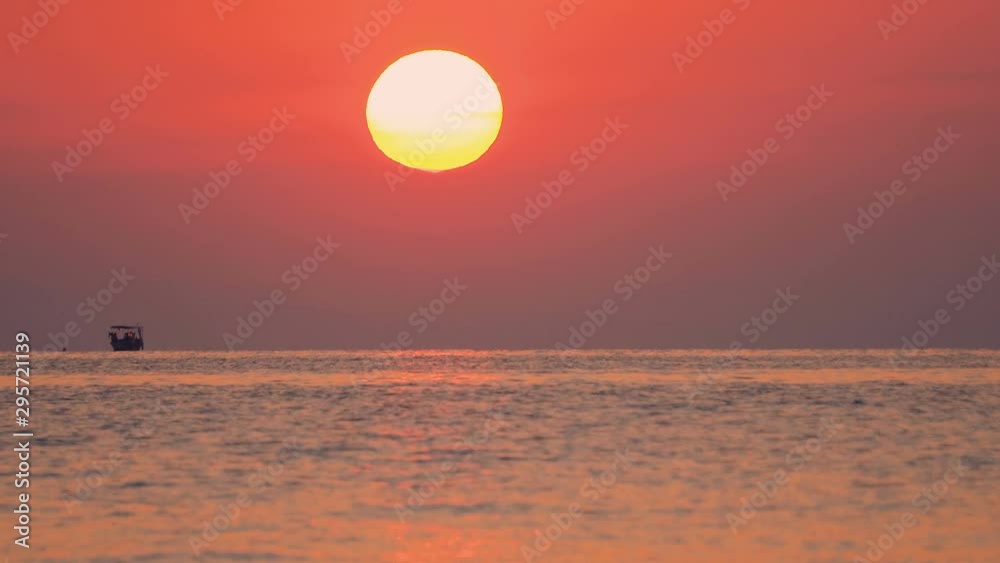 Refugees on a big rubber boat in the middle of the sea at sunset, sunrise Refugees on a big rubber boat in the middle of the sea at sunset, sunrise