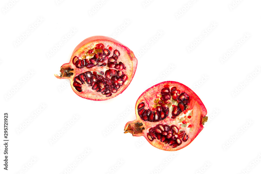 Fototapeta premium Pomegranate fruit isolated on a white background and a cut pomegranate. The concept of eating and eating meals. Eating fruit, providing vitamins.