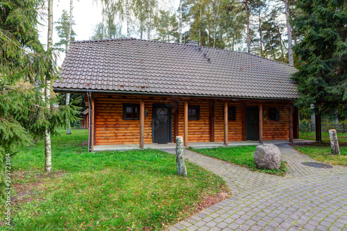 Traditional wooden house in the pine forest. Autumn in Europe.