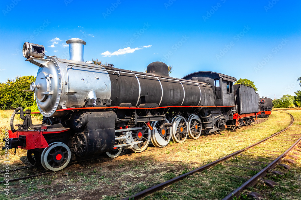 Old retro steel locomotive train standing on the rails in Livingstone, Zambia Old retro steel locomotive train standing on the rails in Livingstone, Zambia