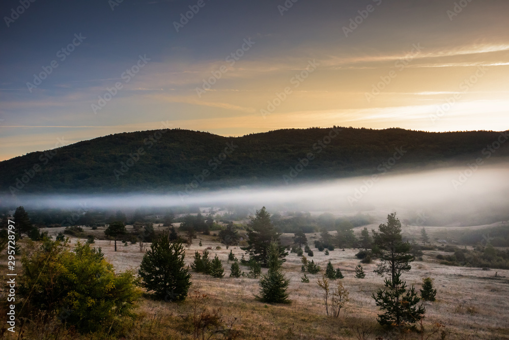 Obraz premium Sunrise on mountain with colorful skyline and fog Near the Drvar in Bosnia and Herzegovina