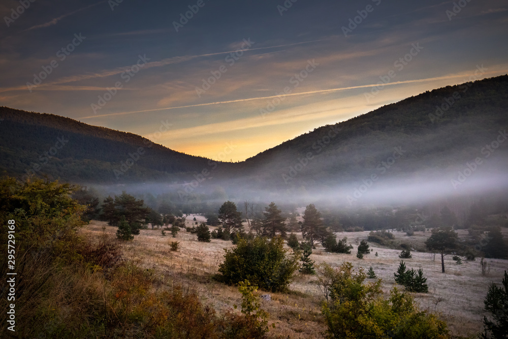 Sunrise on mountain with colorful skyline and fog Near the Drvar in Bosnia and Herzegovina