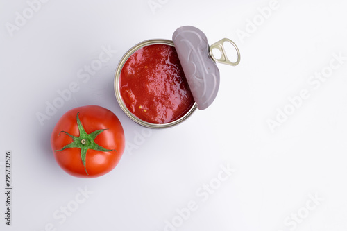 Tin of chopped canned tomatoes with whole fresh tomatoes, isolated on white background, soft light
