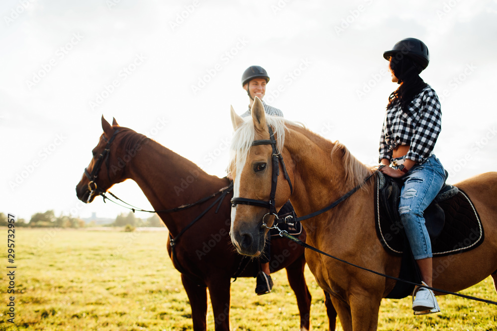 Portrait of happy loving couple spending time with horses on ranch Portrait of happy loving couple spending time with horses on ranch