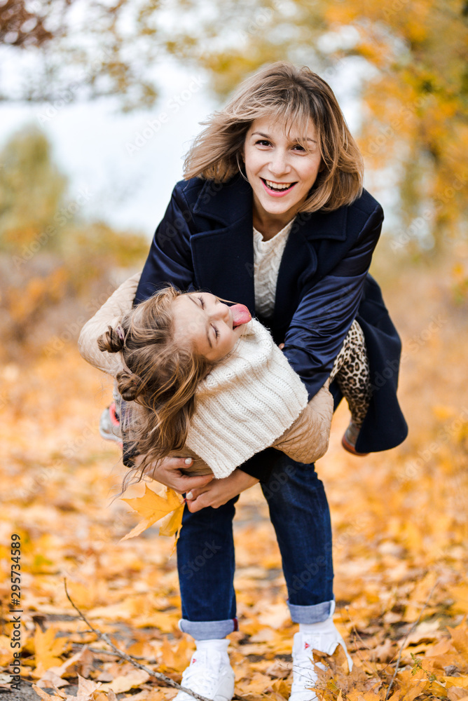mother and daughter in autumn park have fun mother and daughter in autumn park have fun