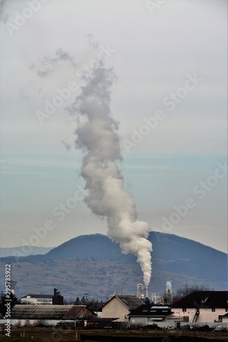 white smoke emanating from a factory chimney