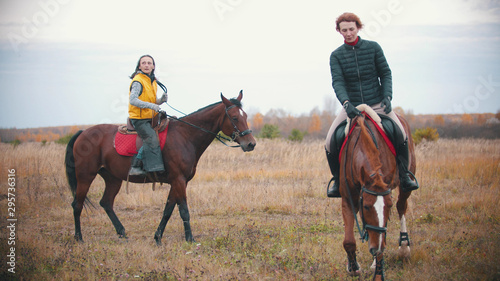 Two women on the horses backs are walking © KONSTANTIN SHISHKIN