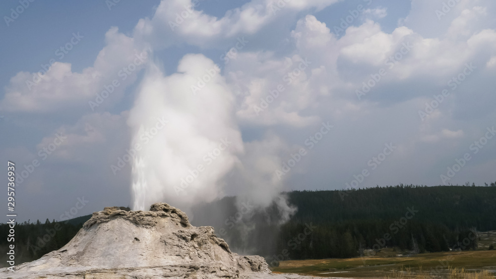 close up of castle geyser erupting in yellowstone