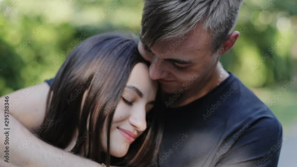 Cheerful, happy, loving couple cuddling tenderly in the city alley Cheerful, happy, loving couple cuddling tenderly in the city alley
