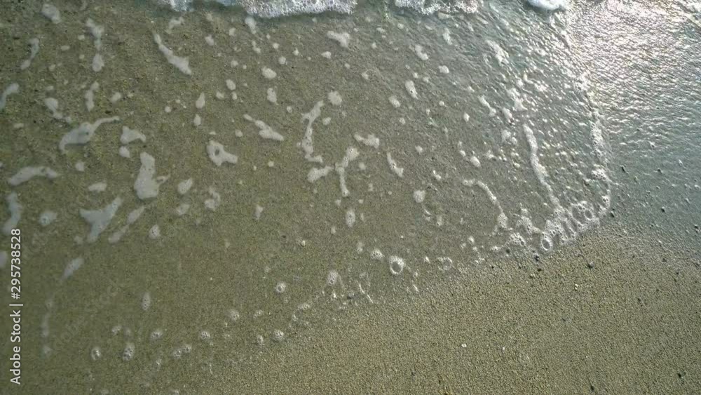 Sea view early summer with light waves, sunlight reflection, turquoise waters and fine yellow sand on the Bulgarian beach