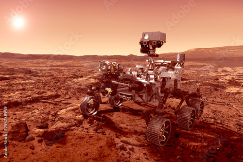 Fototapeta Naklejka Na Ścianę i Meble -  The rover explores the planet Mars, with the sun on the horizon. Elements of this image were furnished by NASA.