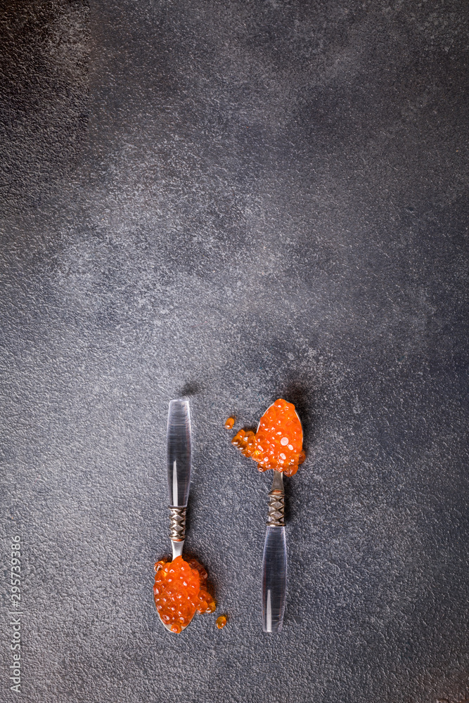 Salmon Red Caviar in a white plate on a dark background. Healthy Food Concept. Snack.Copy space for Text.Seafood. Salmon Red Caviar in a white plate on a dark background. Healthy Food Concept. Snack.Copy space for Text.Seafood.