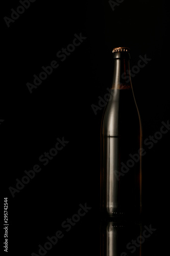 dark glass bottle of beer isolated on black