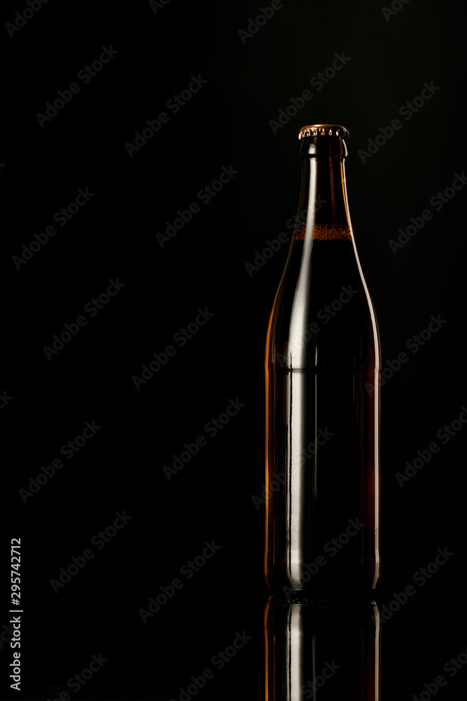 glass bottle of beer isolated on black
