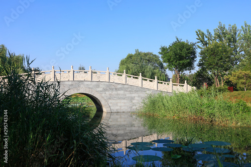 Archaize stone bridge in the park photo