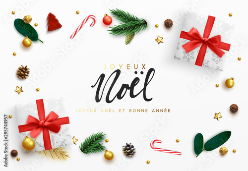 French text Joyeux Noel. Christmas background. Xmas decoration elements design, white gift box, gold ball, pine branches, candies. Chocolate and cane candy. surprise present flat top view.