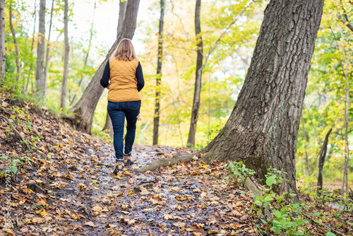 woman hiking alone in autumn woods