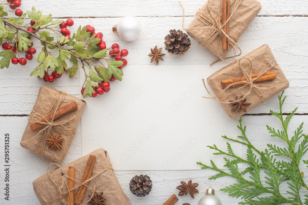 Christmas card with a branch of a Christmas tree with a card, on a white wooden background Christmas card with a branch of a Christmas tree with a card, on a white wooden background